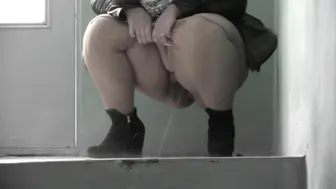 Old fat woman milf pissing in a public entrance.
