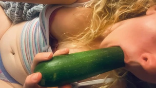 Dumb blonde farm chick keeps fucking herself with her young produce. Takes zucchini and squirts a lot