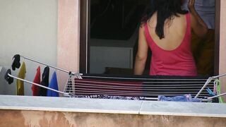 Braless brunette while hanging the laundry